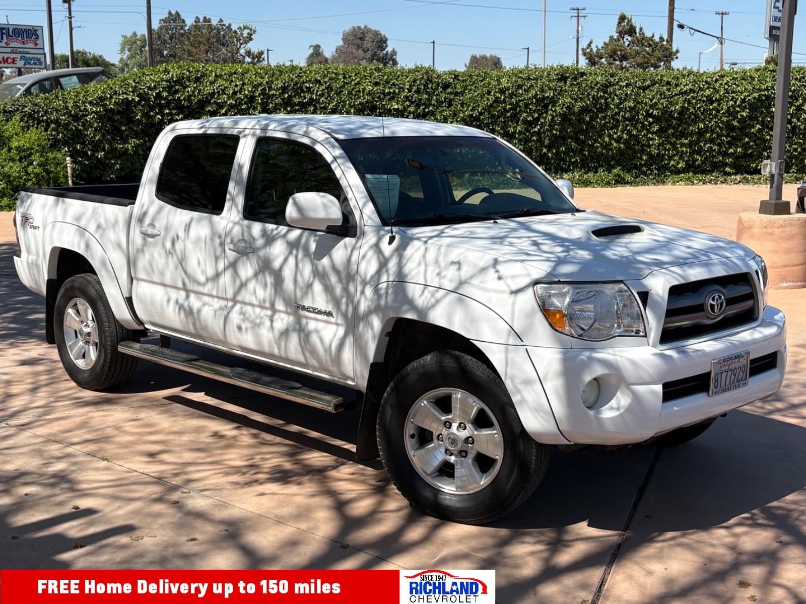 2010 Toyota Tacoma PreRunner in Super Whit — front three-quarter view